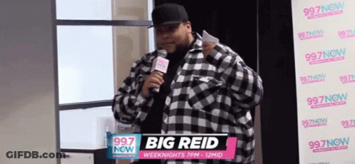 Man In Plaid Shirt Holding Microphone GIF