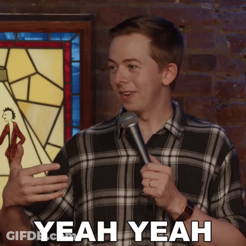 Man In Plaid Shirt Holding Microphone Saying Yeah Yeah GIF