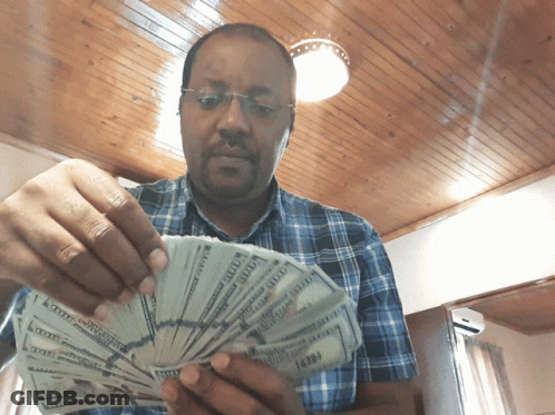 Man In Plaid Shirt Holding Money GIF