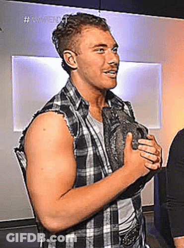 Man In Plaid Shirt Holding Rock GIF