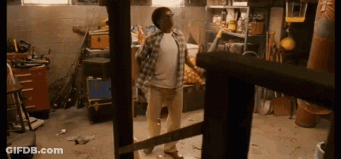 Man In Plaid Shirt Holding Saw GIF