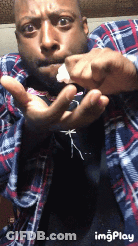 Man In Plaid Shirt Holding Something GIF