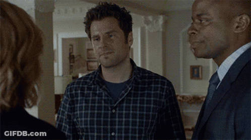 Man In Plaid Shirt Holding Up Fist GIF