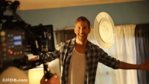 Man In Plaid Shirt Holding White Plate GIF