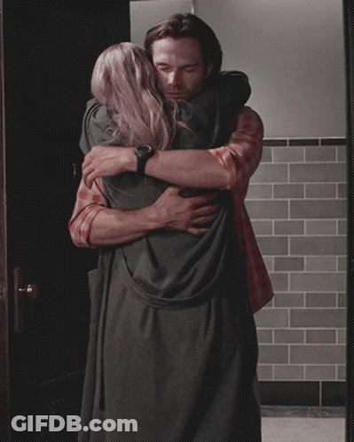 Man In Plaid Shirt Hugging Woman In Black Dress GIF