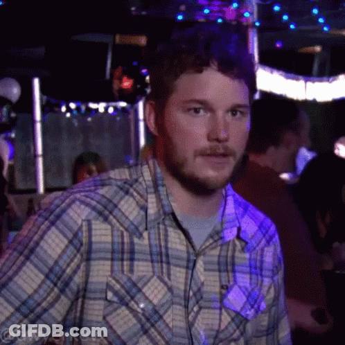 Man In Plaid Shirt In Dark Room With Purple Lights GIF