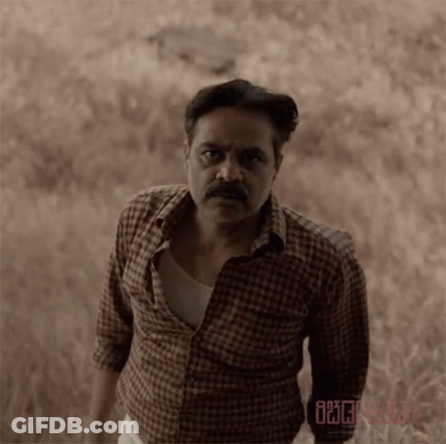 Man In Plaid Shirt In Field GIF