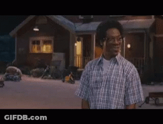 Man In Plaid Shirt In Front Of House At Night GIF