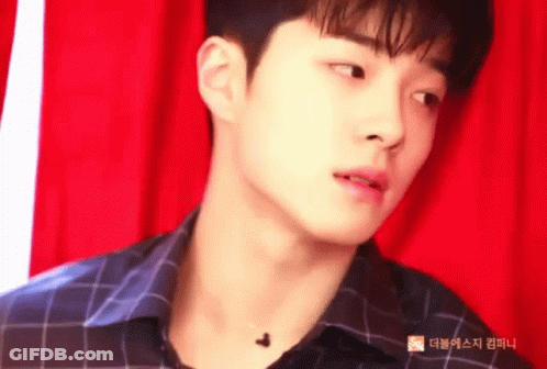 Man In Plaid Shirt In Front Of Red Curtain GIF
