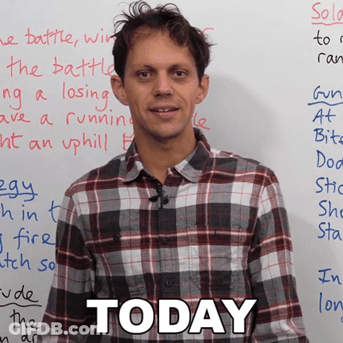 Man In Plaid Shirt In Front Of White Board That Says Today GIF
