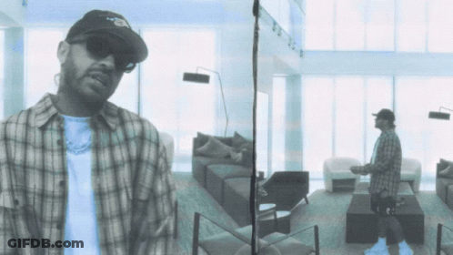 Man In Plaid Shirt In Living Room GIF