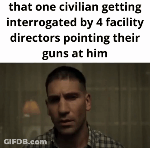 Man In Plaid Shirt Interrogated By Facility Directors GIF