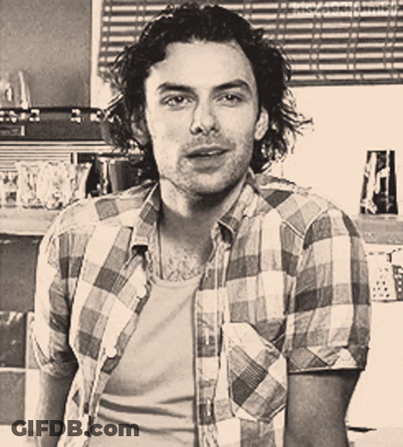 Man In Plaid Shirt Looking At Camera GIF