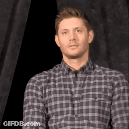 Man In Plaid Shirt Looking At Camera GIF