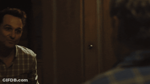 Man In Plaid Shirt Looking At Reflection GIF