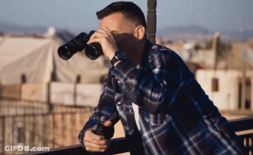 Man In Plaid Shirt Looking Through Binoculars GIF