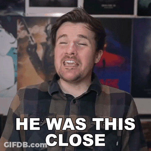 Man In Plaid Shirt Making Face He Was This Close GIF