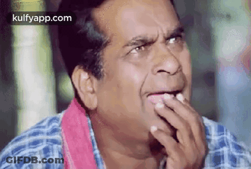 Man In Plaid Shirt Making Funny Face Hand On Mouth GIF