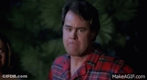 Man In Plaid Shirt Making Funny Face In Front Of Woman GIF