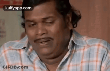 Man In Plaid Shirt Making Funny Face With Eyes Closed GIF