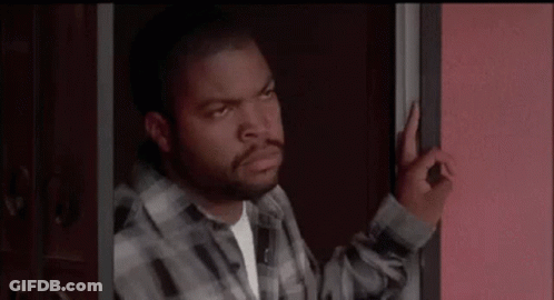 Man In Plaid Shirt Making OK Sign In Doorway GIF