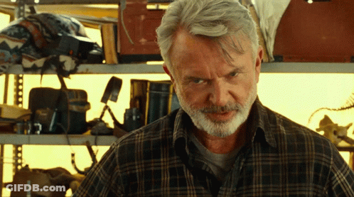 Man In Plaid Shirt Near Shelf GIF
