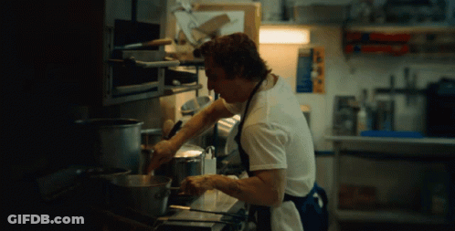 Man In Plaid Shirt Next To Man In Black GIF