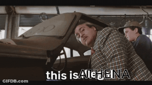 Man In Plaid Shirt Next To Man In Hat GIF