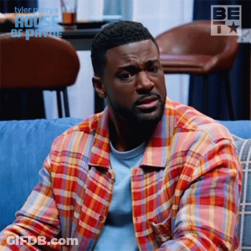 Man In Plaid Shirt On Blue Couch In Front Of House Of Payne GIF