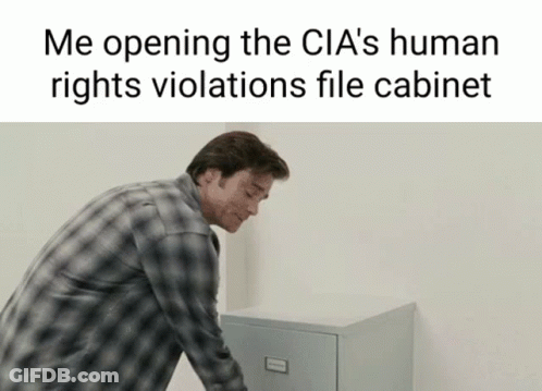 Man In Plaid Shirt Opening File Cabinet GIF