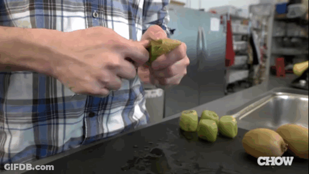 Man In Plaid Shirt Peeling Kiwi GIF