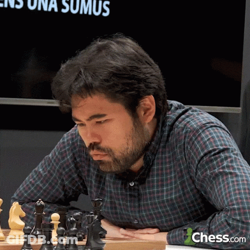 Man In Plaid Shirt Playing Chess GIF