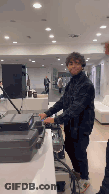 Man In Plaid Shirt Playing Mixer GIF