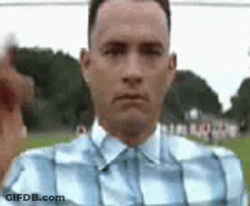 Man In Plaid Shirt Pointing At Camera In Field GIF