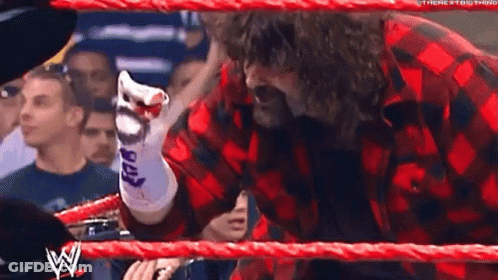 Man In Plaid Shirt Pointing In Wrestling Ring GIF