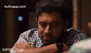 Man In Plaid Shirt Resting Head On Arm Eyes Closed GIF