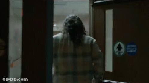Man In Plaid Shirt Running Through Doorway GIF