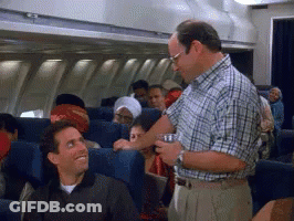 Man In Plaid Shirt Serving Drink On Plane GIF