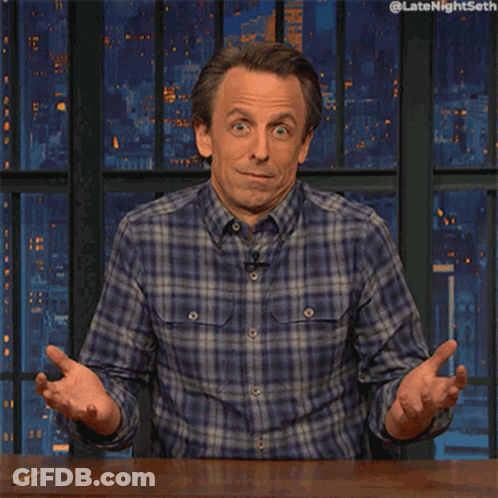 Man In Plaid Shirt Sitting At Table GIF