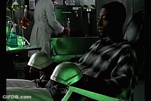 Man In Plaid Shirt Sitting In Green Lab Chair GIF