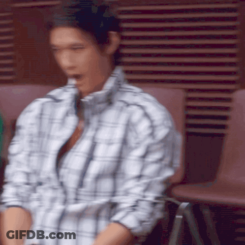 Man In Plaid Shirt Sitting On Chair GIF