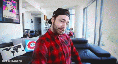 Man In Plaid Shirt Sitting On Couch GIF