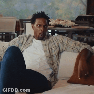 Man In Plaid Shirt Sitting On Couch GIF