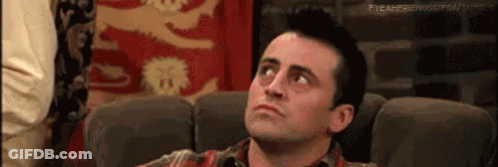 Man In Plaid Shirt Sitting On Couch Looking Up GIF