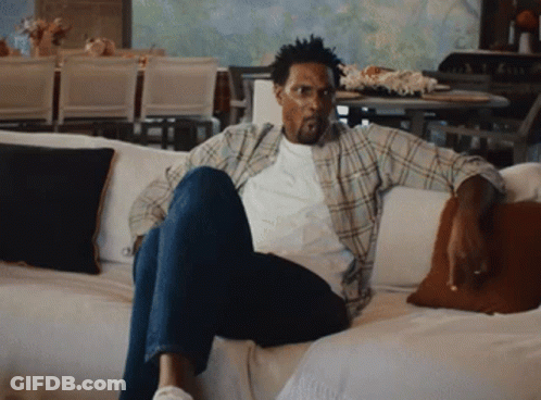 Man In Plaid Shirt Sitting On Couch GIF