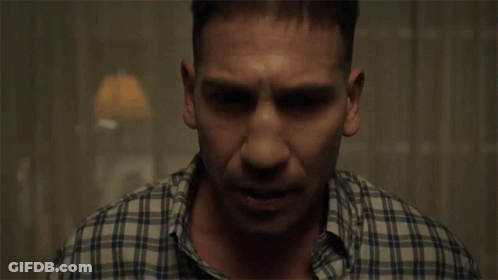 Man In Plaid Shirt Sitting GIF