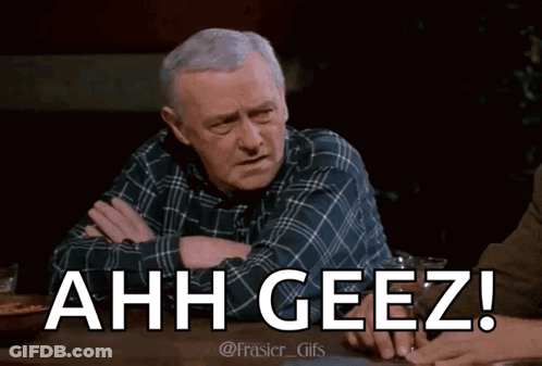 Man In Plaid Shirt Sitting With Arms Crossed Saying Ahh Geez GIF