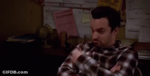 Man In Plaid Shirt Sitting With Crossed Arms GIF