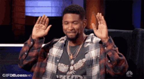 Man In Plaid Shirt Sitting With Hands Up GIF