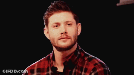Man In Plaid Shirt Smiling Holding Microphone GIF